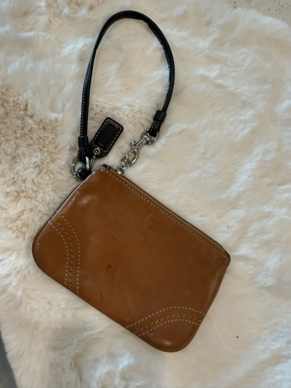 Coach Tan Leather Wristlet with Black Strap , It's staine in some places